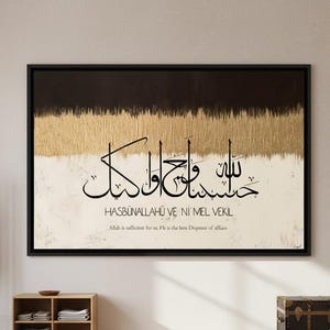 Könnte beinhalten: Große gerahmte Kunst mit arabischer Kalligraphie. Das Kunstwerk zeigt oben ein abstraktes Design in Schwarz und Gold, darunter Weiß- und Beigetöne. Der Text lautet "HASBUNALLAHU VE NI'MEL VEKIL" und "Allah ist uns genug. Er ist der beste Verwalter der Angelegenheiten."
