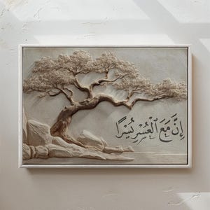 May include: A framed, three-dimensional artwork featuring a detailed relief of a tree with textured leaves and branches. The artwork is in neutral tones, with the word "WHITE" at the bottom. Arabic script is also visible.