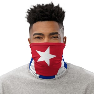 May include: A person wearing a face covering with the Cuban flag printed on it. The flag is red with a white star in the center and blue stripes on the top and bottom.