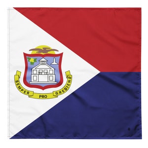May include: A flag of Sint Maarten, a Dutch Caribbean island. The flag is divided into three triangles, with a red triangle at the top, a white triangle in the middle, and a blue triangle at the bottom. The white triangle features the island's coat of arms, which depicts a white building with a yellow roof and a yellow bird flying above it. The coat of arms is surrounded by a yellow ribbon with the words "SEMPER PRO GREDIENS" in black.