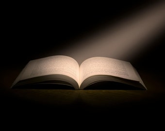 May include: An open book with white pages illuminated by a single spotlight in a dark room.