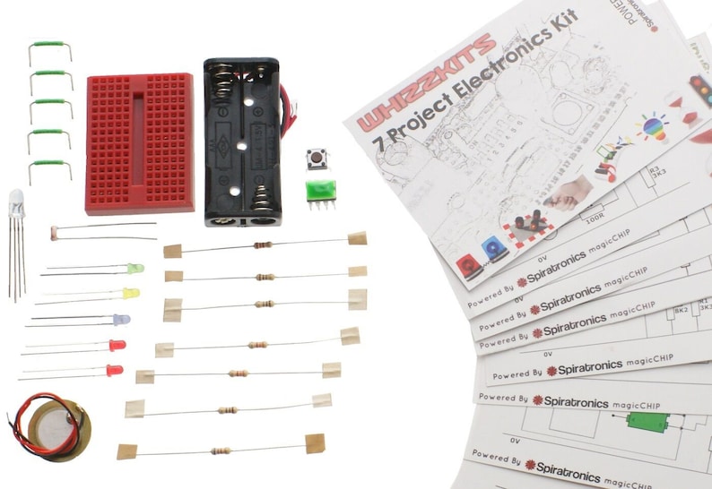 May include: A red breadboard, a battery pack, a green button, a green LED, a red LED, a yellow LED, a white LED, a buzzer, a set of resistors, and a set of jumper wires. The image also includes a set of instructions for a 7 project electronics kit powered by Spiratronics magicCHIP.