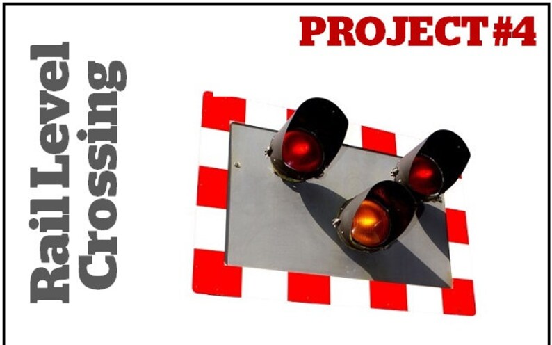 May include: A red, white, and black railroad crossing sign with three traffic lights. The top two lights are red, and the bottom light is yellow. The sign reads "PROJECT #4".
