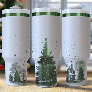 May include: Three white insulated travel mugs with green accents and handles. Each mug features a different winter scene: a Christmas tree, a house, and a group of trees. The mugs are decorated with a scattering of white stars.