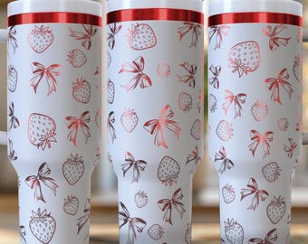 May include: Three white stainless steel travel mugs with red lids and a pink and white strawberry and bow pattern.