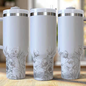 May include: Three white stainless steel tumblers with a floral design. The tumblers have a silver lid and a handle.