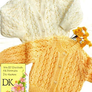 May include: Two knitted cardigans, one cream and one yellow-orange, with a button-up front and intricate openwork design. The image includes text indicating the pattern uses 16 to 22 inches of yarn, 4 & 3.75mm pins, and 3 to 4 buttons. The text also includes the letters "DK".