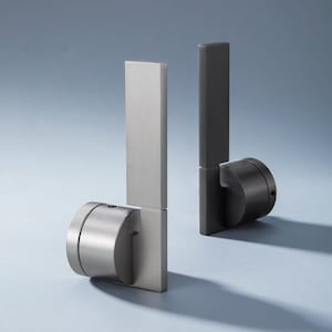 May include: Two silver door handles with a rectangular design and a round base. The handles are attached to a wall.