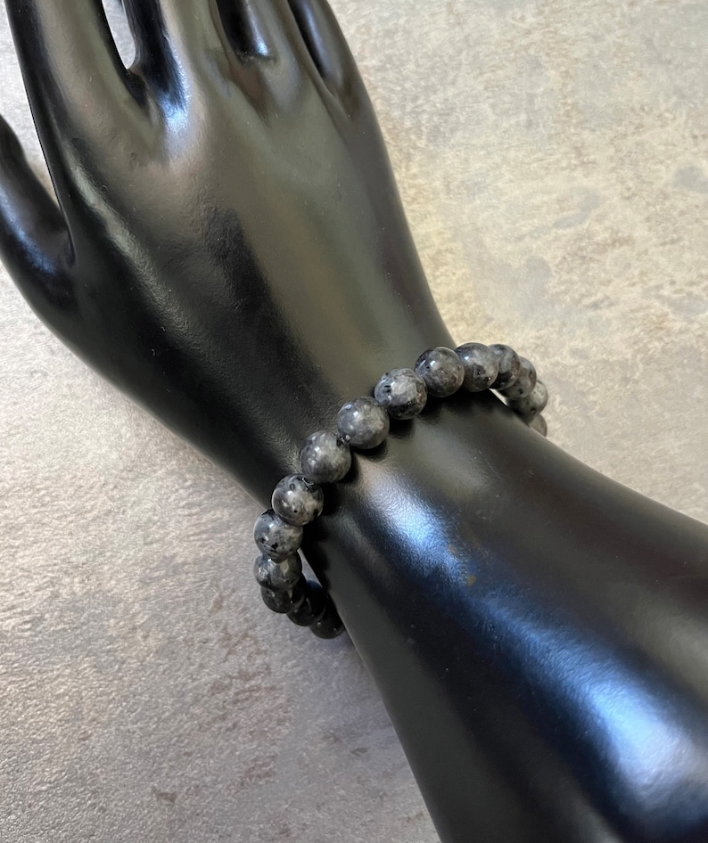 May include: A black beaded bracelet made of labradorite stones.