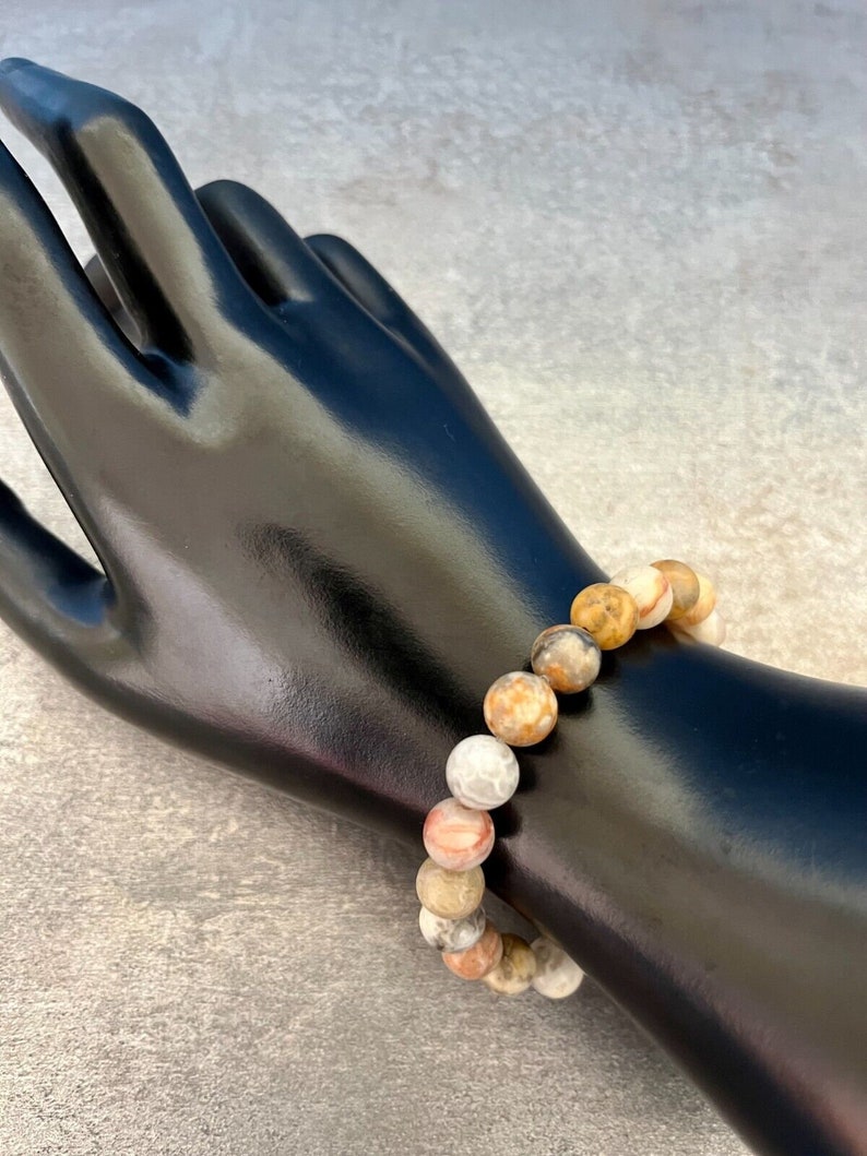 May include: A bracelet made of brown, white, and orange agate beads.