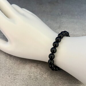 May include: A black beaded bracelet with round beads.