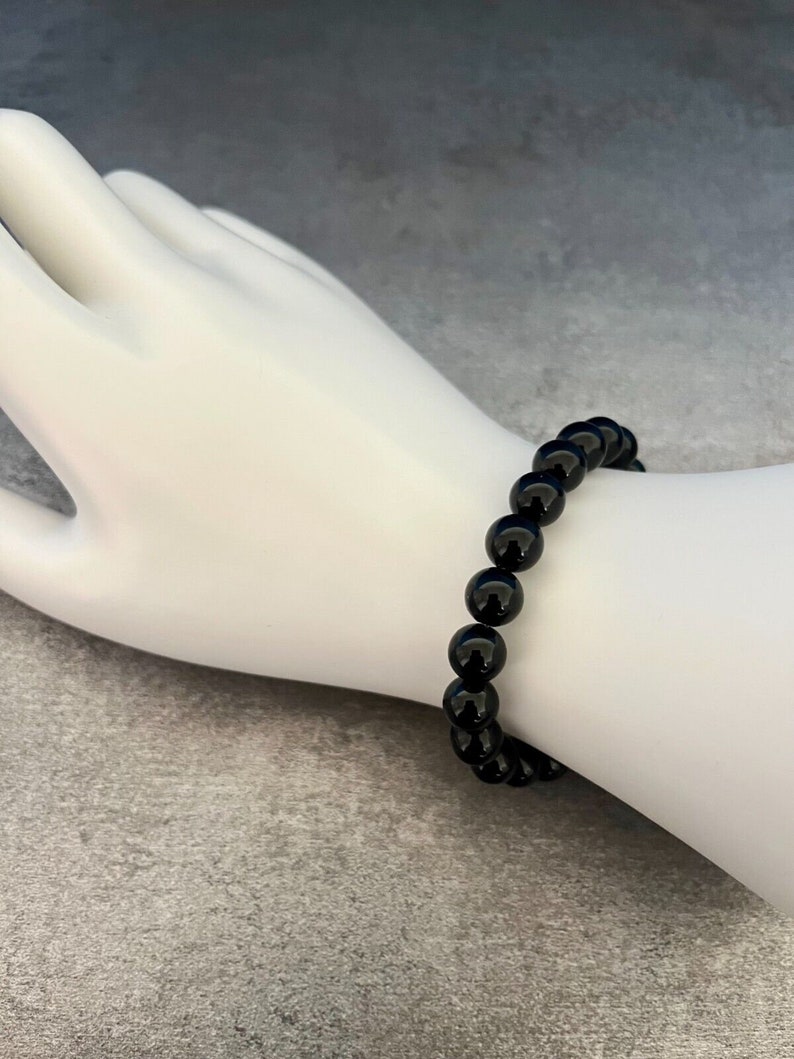 May include: A black beaded bracelet with round beads.