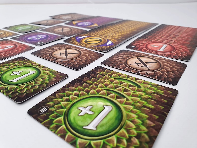 May include: A set of game cards with different numbers and symbols. The cards have a brown background with a green, leafy pattern. The symbols include a sword and a plus sign.