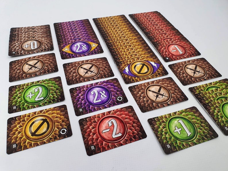May include: A set of game cards with various symbols and numbers. The cards have a brown background with a pattern of scales. The symbols include swords, a circle with a slash through it, and a circle with a number inside. The numbers include 0, 1, 2, -1, -2, and 2x.
