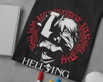 May include: Black t-shirt with a white graphic of a character holding a gun. The graphic is surrounded by a red circle with the text "Hellsing" and a series of symbols in red.