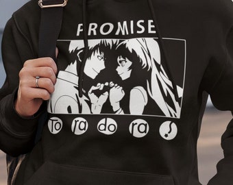 May include: Black hoodie with a white graphic print of two anime characters. The text "PROMISE" is above the characters and the text "to ra do ra?" is below the characters.