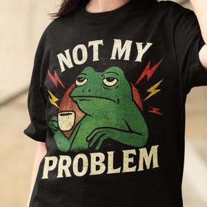 Funny Frog Quote Unisex Softstyle T-Shirt, Vintage Aesthetic Not My Problem Tee, Joke Animal Lover Gift, Sarcastic Graphic Tee, Retro Humor