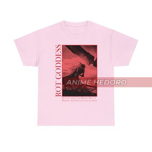May include: Pink t-shirt with a graphic print of a character from a video game. The graphic is in red and black and features a sword and the text "ROT GODDESS" and "ANIME HEDORO". The text below the graphic reads "Heed my words. I am Malenia. Blade of Miquella. And I have never known defeat."
