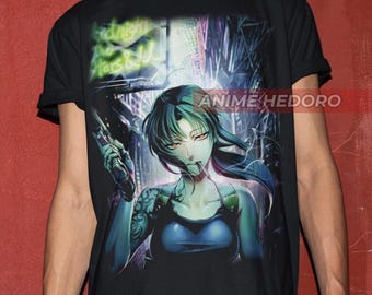 May include: Black t-shirt with a graphic print of an anime character holding a gun. The character has long black hair and green eyes. The background is a city scene with neon lights.