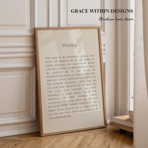 May include: A rectangular framed wall art piece featuring the text of Psalm 23 in black serif font on a light beige background. The frame is made of light-toned wood. The text reads: Psalm 23, The Lord is my shepherd, I shall not want.