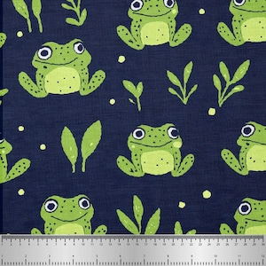 May include: Navy blue fabric featuring a repeating pattern of cartoon frogs in light green and yellow. The frogs have large eyes and are surrounded by green leaves and small yellow dots. Ideal for craft projects.