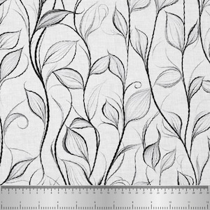 May include: Fabric with a black and white floral design. The pattern features stylized leaves and vines in shades of grey and black against a white backdrop. A ruler is at the bottom, with measurements in inches.