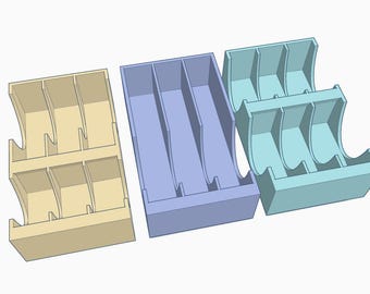 May include: Three 3D-printed storage organizers in light yellow, lavender, and light blue. Each organizer has a rectangular base and vertical dividers, creating multiple compartments. The sides have a curved design.
