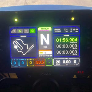 May include: A black digital display screen with various racing data, including lap times, fuel levels, and a track map. The screen displays the text "MOZA" at the bottom. The screen has a green and blue border.