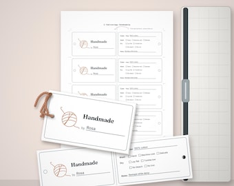 May include: A sheet of white rectangular fold-over tags with a brown yarn ball icon and the text Handmade by Rosa. The tags include care instructions for 100% cotton, wash and dry settings, and a notes line. A paper trimmer is visible on the right.