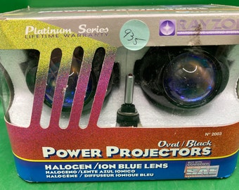May include: A pair of black oval power projector headlights with blue ion lenses. The packaging features the brand name "Rayzor" and the text "Platinum Series Lifetime Warranty".