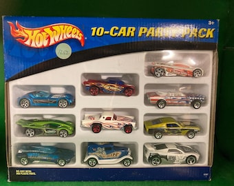 May include: A blue box with the Hot Wheels logo and the text "10-Car Pack" on the front. The box contains 10 miniature toy cars, including a blue car, a red car, a white car, a green car, and a yellow car.