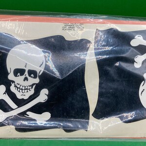 May include: Two black and white pirate flags with a skull and crossbones design. The flags are packaged in a clear plastic bag.