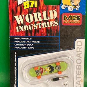 May include: Tech Deck 57 skateboard featuring a green deck with a World Industries logo and a smiley face graphic. The skateboard is part of the Mini Series 3 collection.