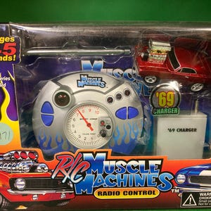 May include: A white ceramic mug with a black handle and the text "But First, Coffee" in a bold, black font. The mug is set against a blurred background, suggesting a cozy setting.