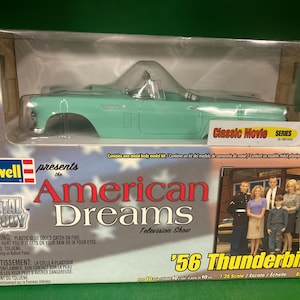 May include: A mint green '56 Thunderbird model car kit by Revell. The box features the text "American Dreams Television Show" and "Classic Movie Series." The kit includes a metal body and is easy to build. The scale is 1:25.