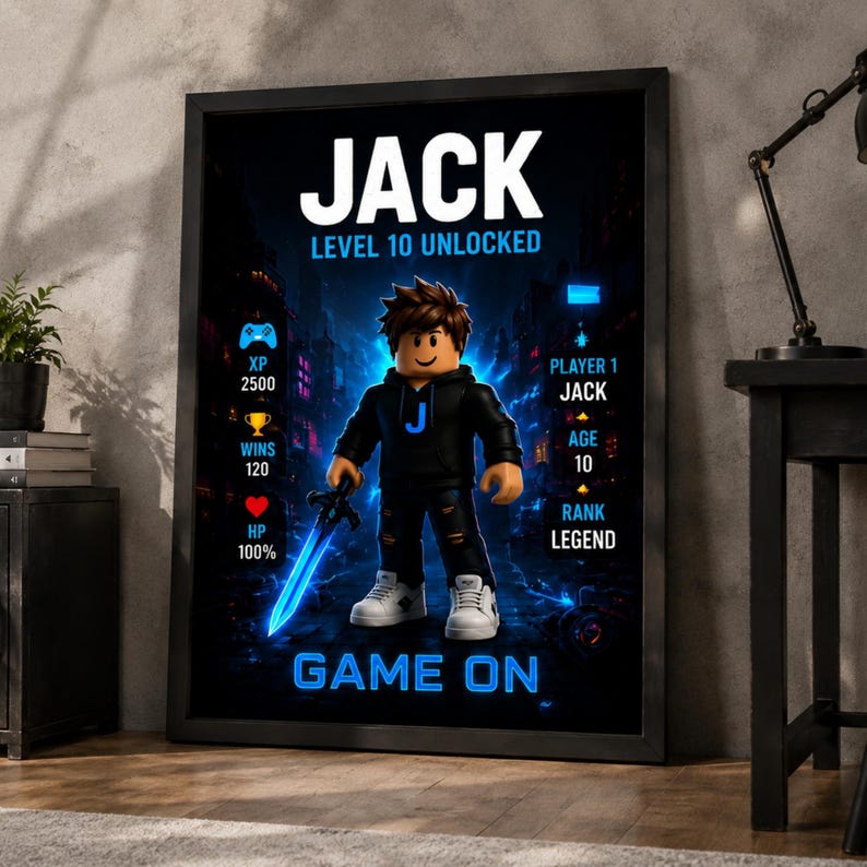 May include: A framed poster featuring a cartoon character in a black hoodie with a blue J, holding a glowing blue sword. The text reads JACK, LEVEL 10 UNLOCKED, PLAYER 1, AGE 10, RANK LEGEND, and GAME ON, with icons for XP 2500, WINS 120, and HP 100%.