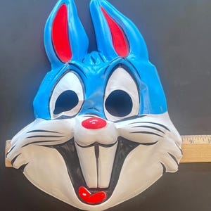 Vintage masks: Bugs Bunny and Sylvester. 1970s. It is a plastic mask depicting the famous cartoon characters. Halloween costume accessory