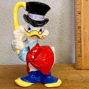 Vintage figurine of Uncle Scrooge McDuck, a character from Disney's Duck universe. collectible from the 1960s, by Walt Disney Productions.