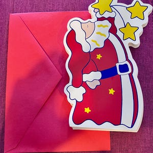 Conjunto de 12 tarjetas navideñas vintage que representan a Papá Noel cargando un saco y alcanzando estrellas. Tarjetas de felicitación navideñas.