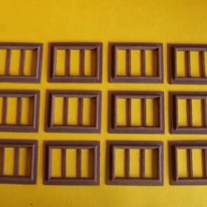 以下が含まれることがあります： 3つの窓枠が4列に並んだ、12個の茶色の木製の窓枠。各窓枠には3つの窓ガラスがあります。