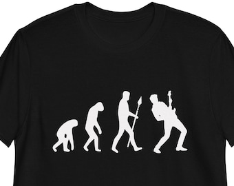 May include: Black t-shirt featuring a white silhouette of the evolution of man, culminating in a man playing an electric guitar.