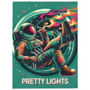 May include: An astronaut in a green, orange, and blue spacesuit floats in a swirling galaxy with a trail of smoke behind them. The text "PRETTY LIGHTS" is at the bottom of the image.