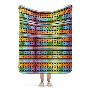 May include: A colorful throw blanket with a geometric pattern of interlocking shapes in shades of red, orange, yellow, green, blue, indigo, and violet. The blanket is made of soft, comfortable fabric and is perfect for adding a pop of color to any room.