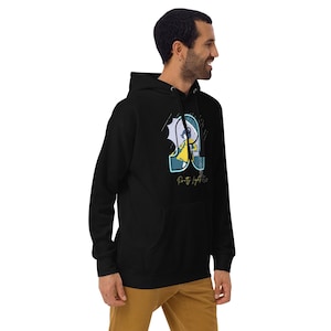 May include: Black hooded sweatshirt with a front graphic. The graphic features a stylized letter "R" with a cartoon figure in a yellow raincoat. The text "Pretty Light Rain" is below the graphic. The sweatshirt has a front pocket and a drawstring hood.