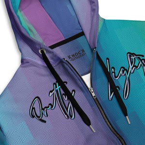 May include: A blue and purple zip-up hoodie with a geometric pattern and the text "Pretty Lights" and "Knock Official" printed on it.