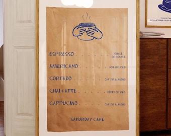 May include: A framed menu with a brown paper background and blue text listing coffee drinks like espresso, americano, cortado, chai latte, and cappuccino. The text "Saturday Cafe" is at the bottom of the menu.
