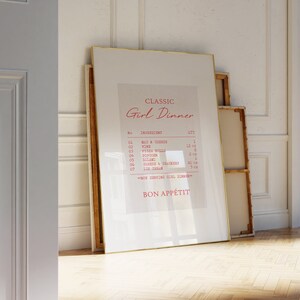 May include: A framed print with a gold frame and a white background. The print features a list of items with the title "Classic Girl Dinner" and the text "Bon Appetit" at the bottom.