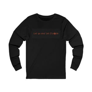 May include: Black long-sleeve shirt with the text "Let go and let Claude" in orange. The shirt has a crew neck and is made of a soft material. The text is centered on the chest.