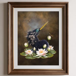 May include: A framed wall art print featuring a dark-feathered bird with a long yellow beak, positioned among white water lilies and green lily pads. The background is a dark, moody brown with two small dragonflies hovering near the bird.