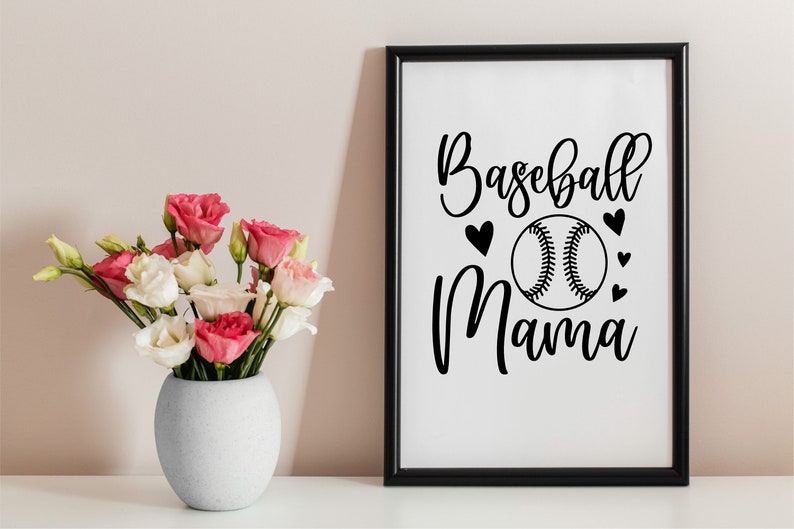 May include: A black and white framed print with the text "Baseball Mama" and a baseball graphic. The print is on a white background and has small hearts around the baseball.